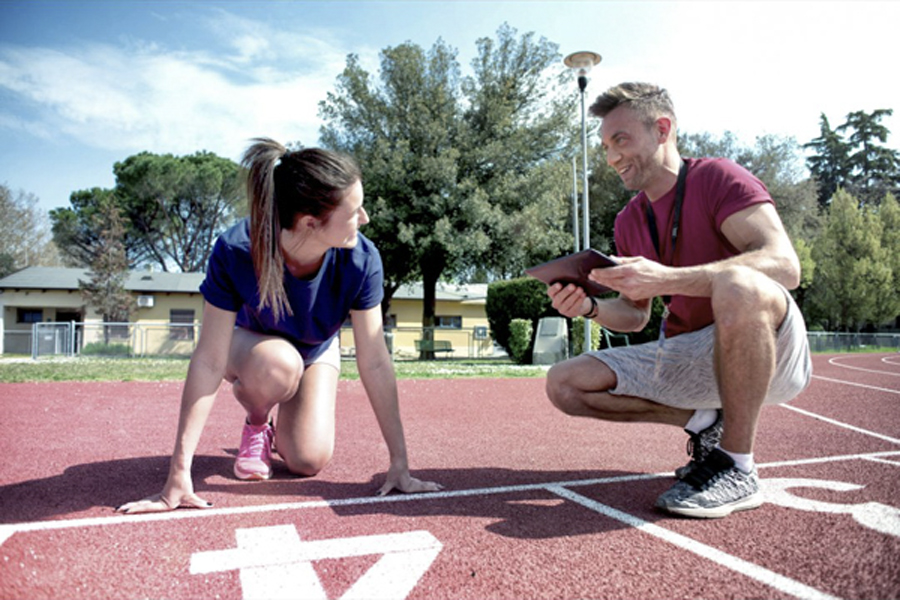 a winning relay runner does laps with her coach